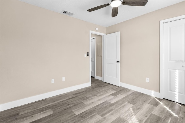 unfurnished bedroom featuring light hardwood / wood-style floors and ceiling fan