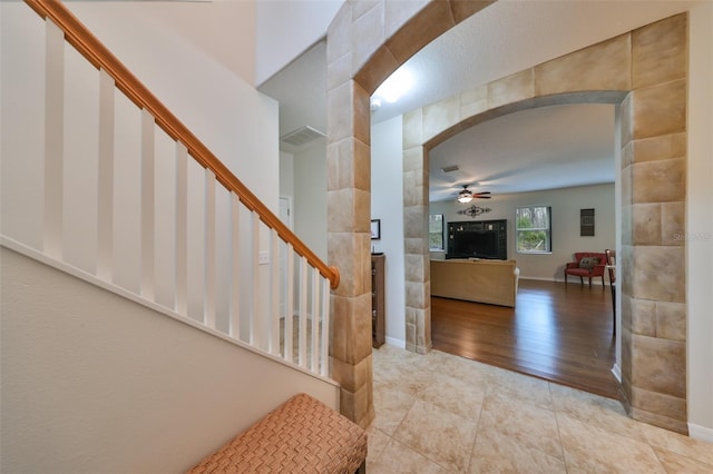 entrance foyer with ceiling fan and light hardwood / wood-style flooring