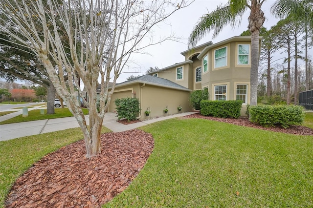 view of front of property featuring a garage and a front yard