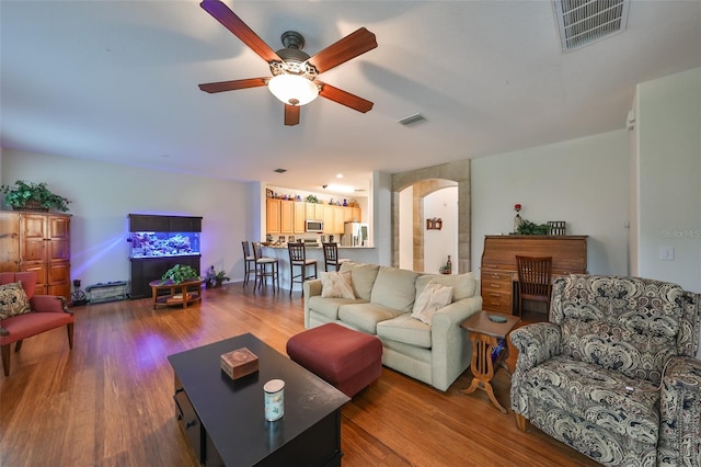 12127 Luftburrow Ln, Hudson, FL 34669 - living area featuring wood finished floors, arched walkways, and visible vents