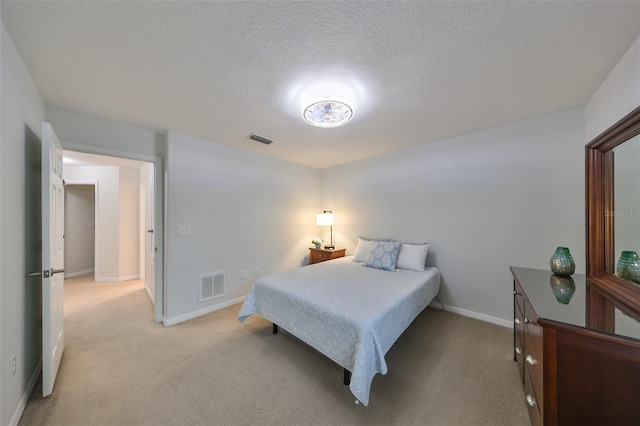 12127 Luftburrow Ln, Hudson, FL 34669 - bedroom with a textured ceiling, light colored carpet, and visible vents
