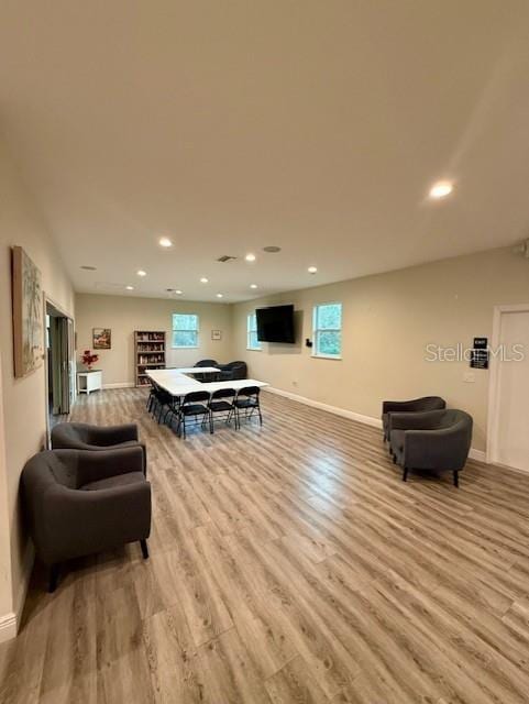 12127 Luftburrow Ln, Hudson, FL 34669 - living room featuring baseboards, recessed lighting, and light wood finished floors