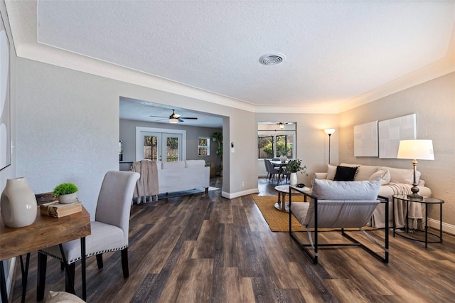 living room featuring a textured ceiling, dark hardwood / wood-style floors, and french doors