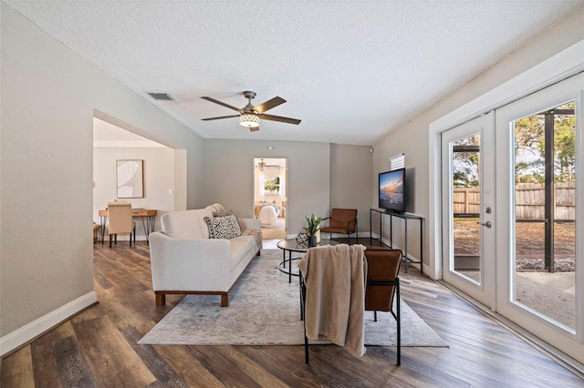 living room with a textured ceiling, dark hardwood / wood-style floors, ceiling fan, and french doors