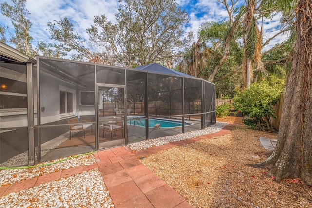 view of swimming pool featuring a patio and a lanai