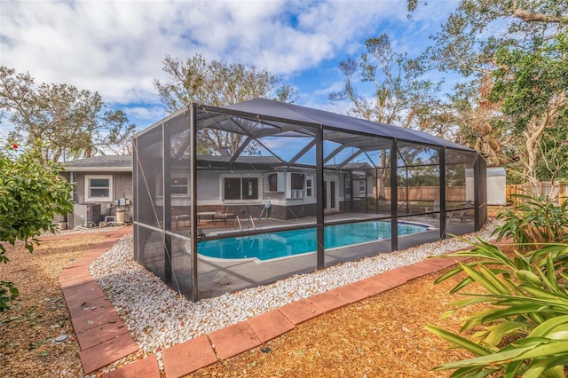 view of swimming pool with a lanai and a patio