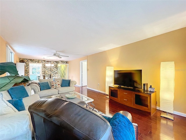 living room featuring ceiling fan and dark hardwood / wood-style flooring