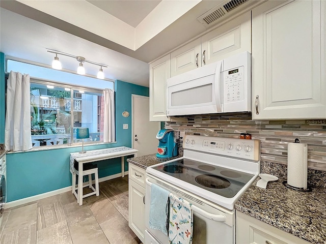 kitchen featuring white cabinets, tasteful backsplash, dark stone counters, and white appliances