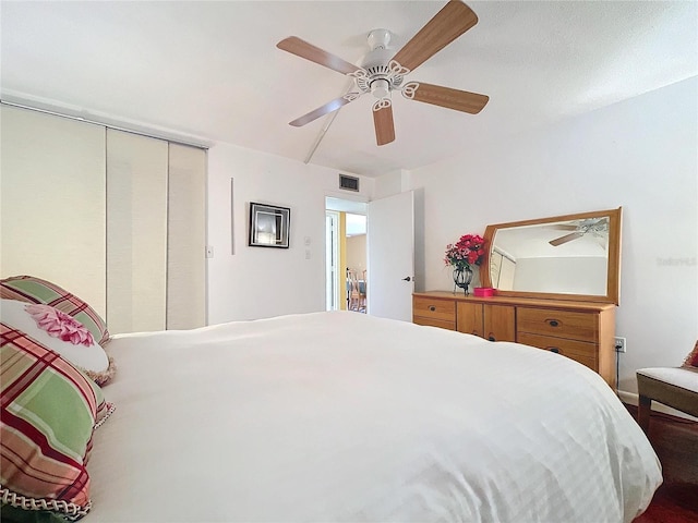 bedroom with ceiling fan and a closet