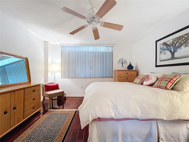 bedroom featuring a textured ceiling, ceiling fan, and dark hardwood / wood-style floors