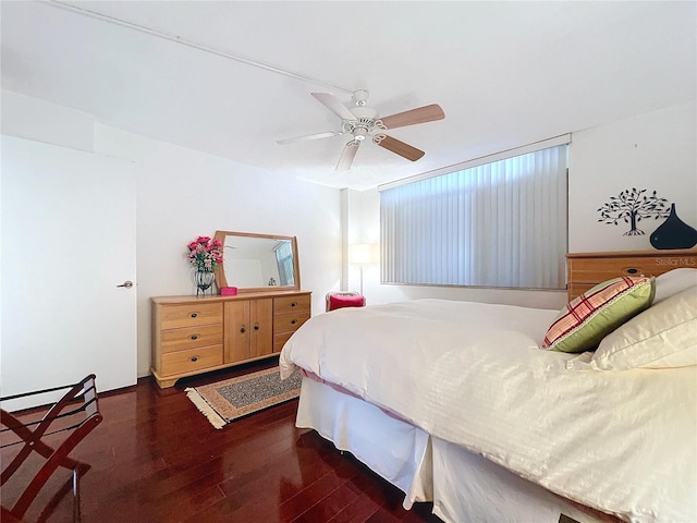 bedroom with dark wood-type flooring and ceiling fan