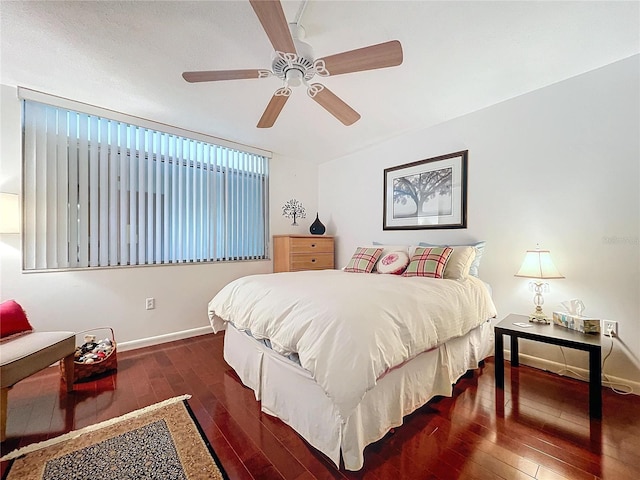 bedroom with ceiling fan and dark hardwood / wood-style floors