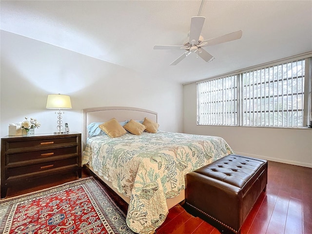 bedroom with ceiling fan and dark hardwood / wood-style flooring