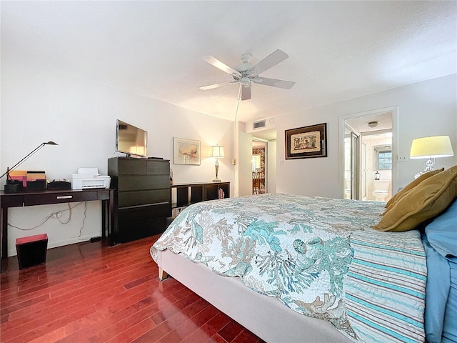 bedroom with ensuite bath, ceiling fan, and dark wood-type flooring