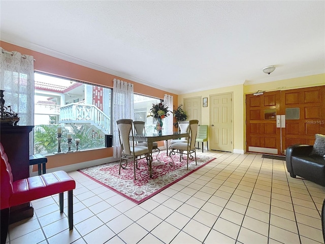 tiled dining space featuring ornamental molding