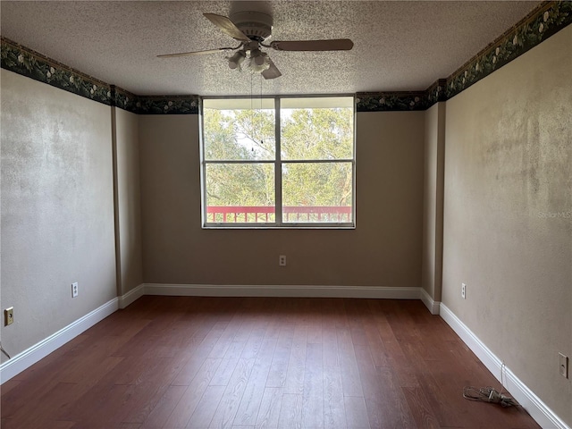 empty room featuring ceiling fan, hardwood / wood-style floors, and a textured ceiling