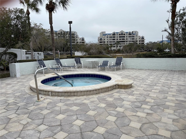 view of pool featuring a patio area and a hot tub