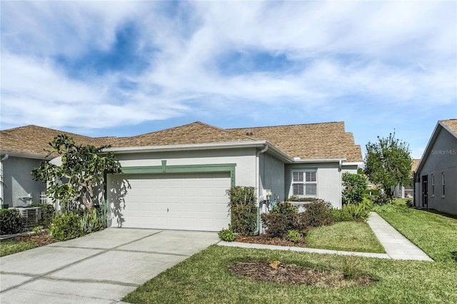 single story home featuring a garage, a front yard, and central air condition unit