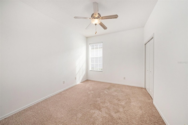 carpeted empty room with ceiling fan