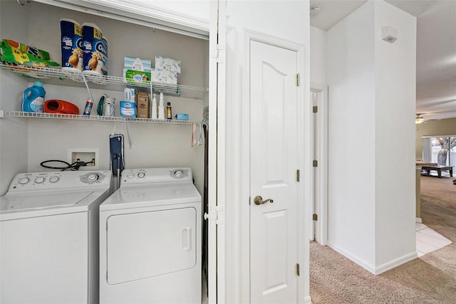 laundry area featuring light carpet, ceiling fan, and washing machine and clothes dryer