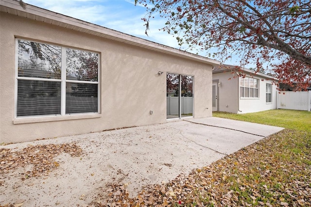 back of property with a patio and a yard