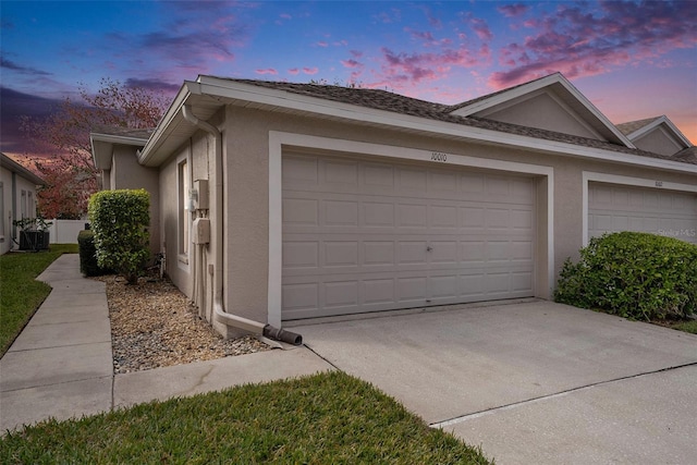 garage at dusk with central air condition unit