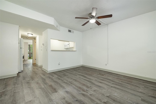 spare room featuring ceiling fan and hardwood / wood-style floors