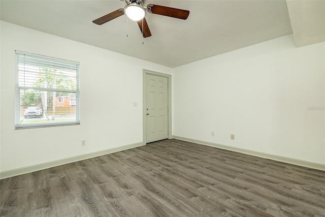 spare room with ceiling fan and dark hardwood / wood-style flooring