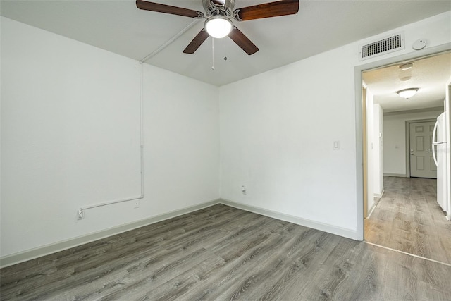 spare room with light hardwood / wood-style floors and ceiling fan