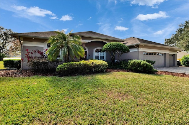 view of front of house with a garage and a front lawn