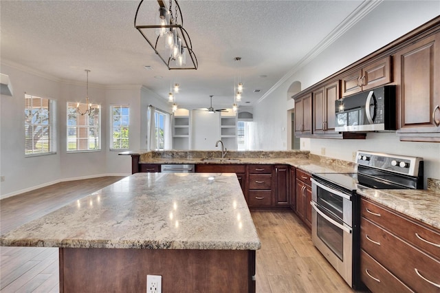 kitchen featuring a center island, hanging light fixtures, and appliances with stainless steel finishes