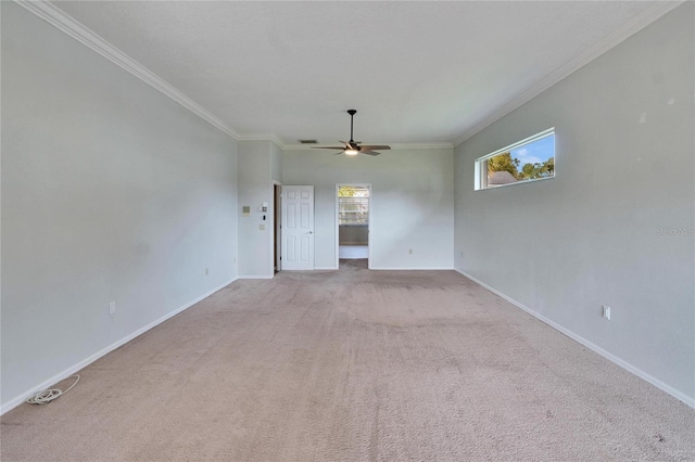 carpeted empty room with ceiling fan and ornamental molding