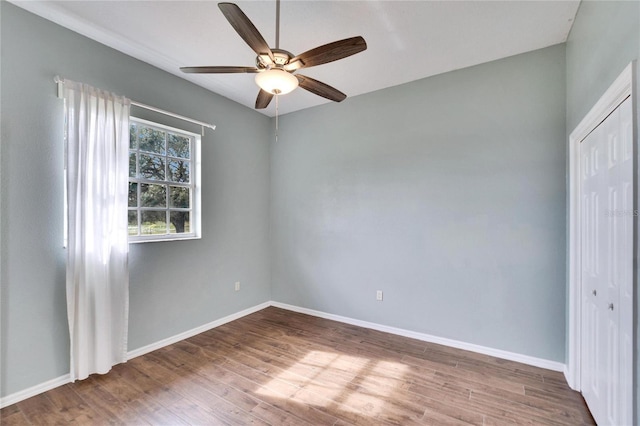 unfurnished bedroom featuring a closet, ceiling fan, and hardwood / wood-style floors