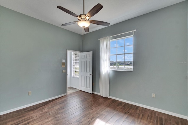 unfurnished room featuring ceiling fan and dark hardwood / wood-style flooring