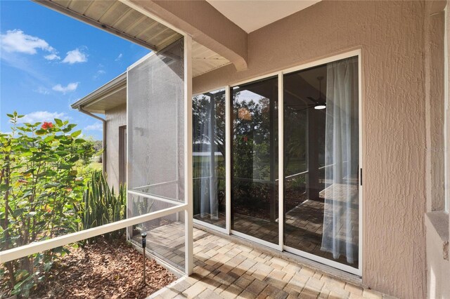 view of exterior entry with a balcony