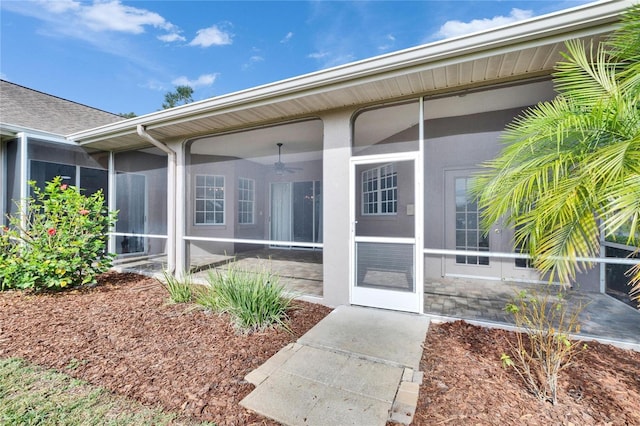 entrance to property featuring ceiling fan