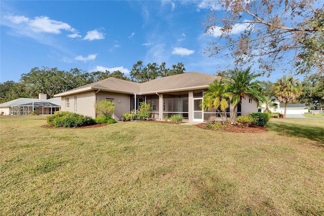 ranch-style home featuring a front lawn and a sunroom