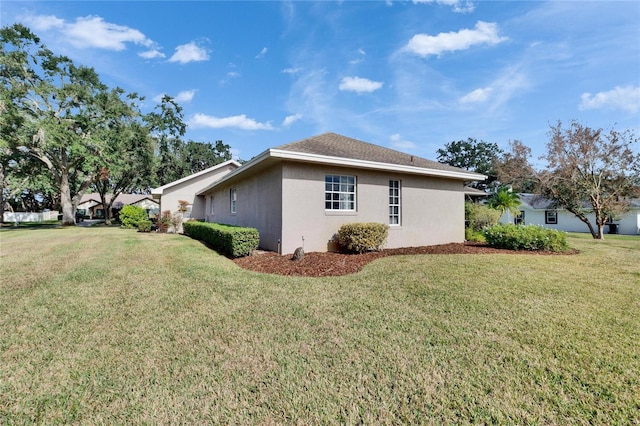 view of home's exterior with a yard