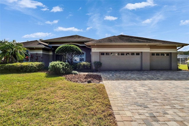 prairie-style home with a garage and a front yard