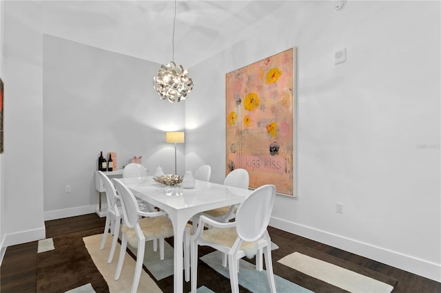 dining room featuring a notable chandelier and dark hardwood / wood-style floors