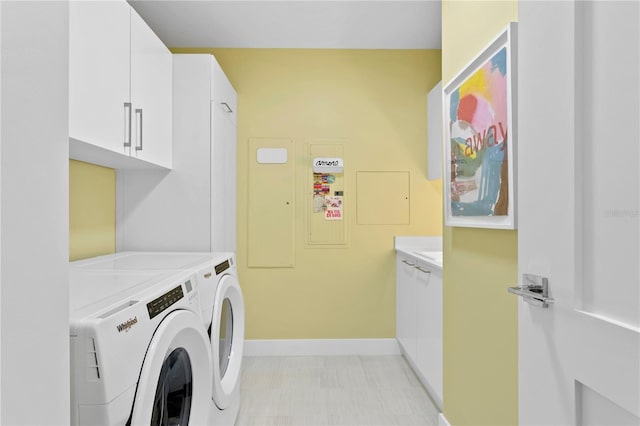 laundry area with washer and dryer and cabinets