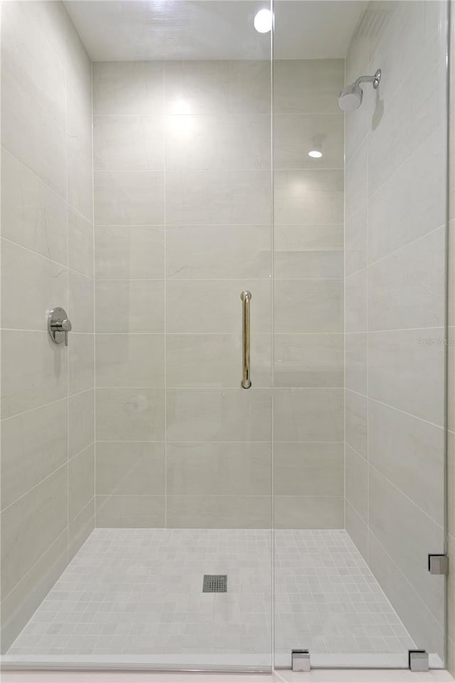 bathroom with a shower with door