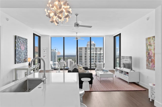 living room with a healthy amount of sunlight, sink, and floor to ceiling windows