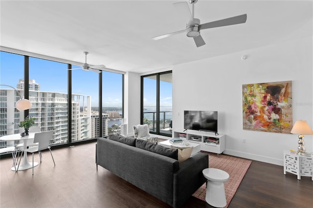 living room featuring ceiling fan, dark hardwood / wood-style floors, and expansive windows