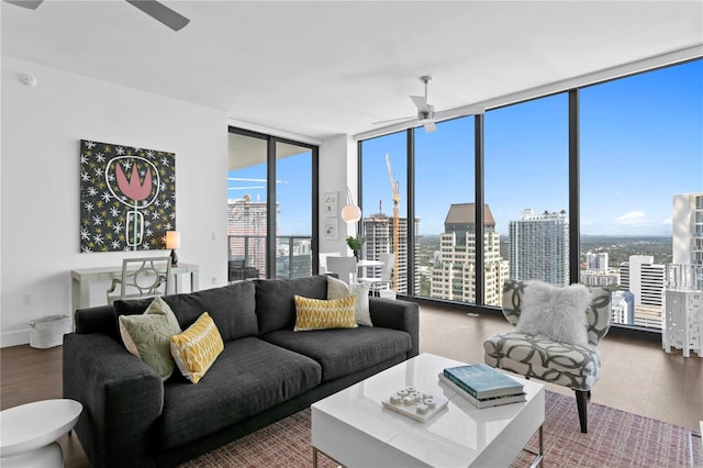 living room featuring ceiling fan, floor to ceiling windows, and hardwood / wood-style floors