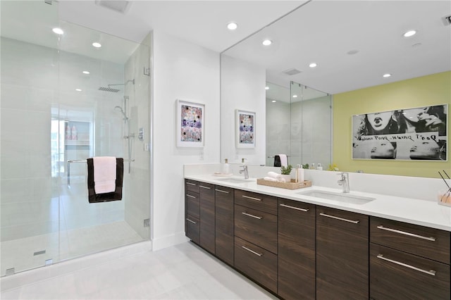 bathroom featuring a shower with door, vanity, and tile patterned flooring