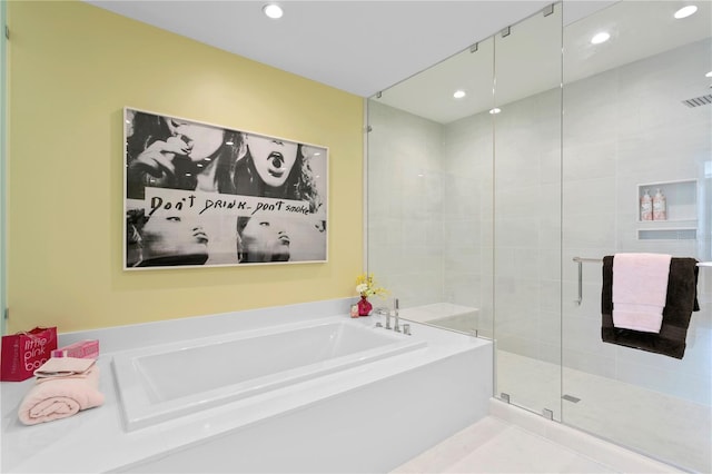 bathroom featuring tile patterned floors and separate shower and tub