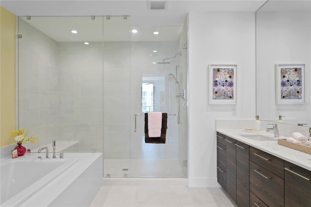 bathroom featuring independent shower and bath, tile patterned flooring, and vanity