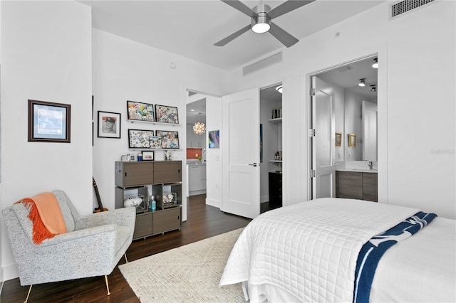 bedroom featuring ceiling fan, dark hardwood / wood-style flooring, sink, and ensuite bath