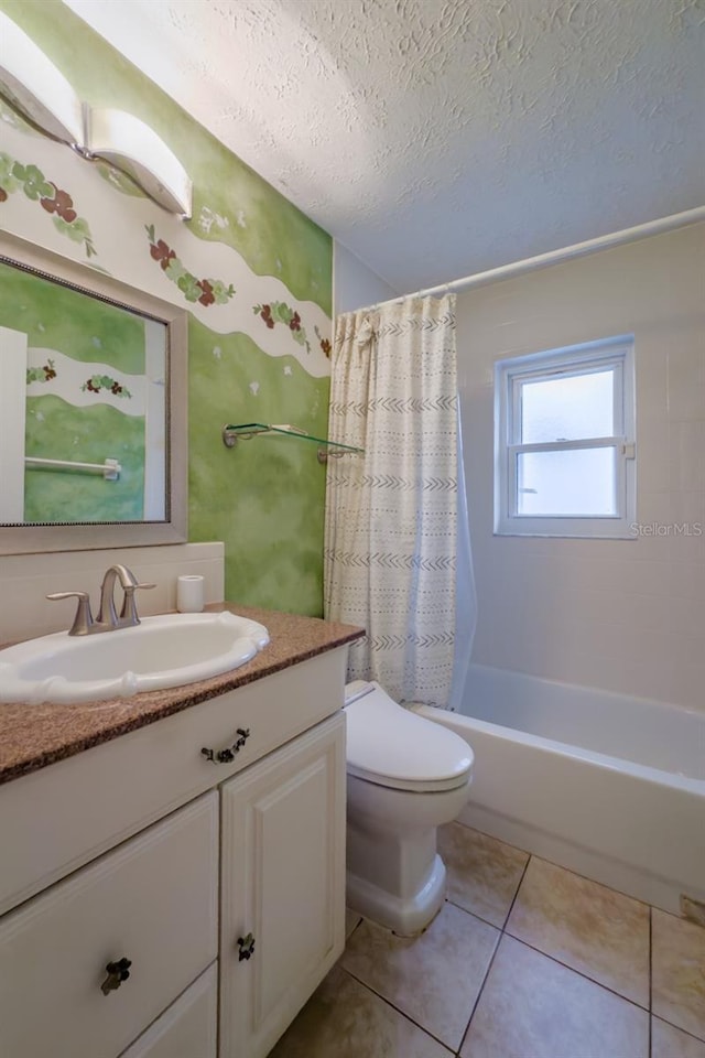 full bathroom with toilet, tile patterned flooring, shower / bathtub combination with curtain, a textured ceiling, and vanity